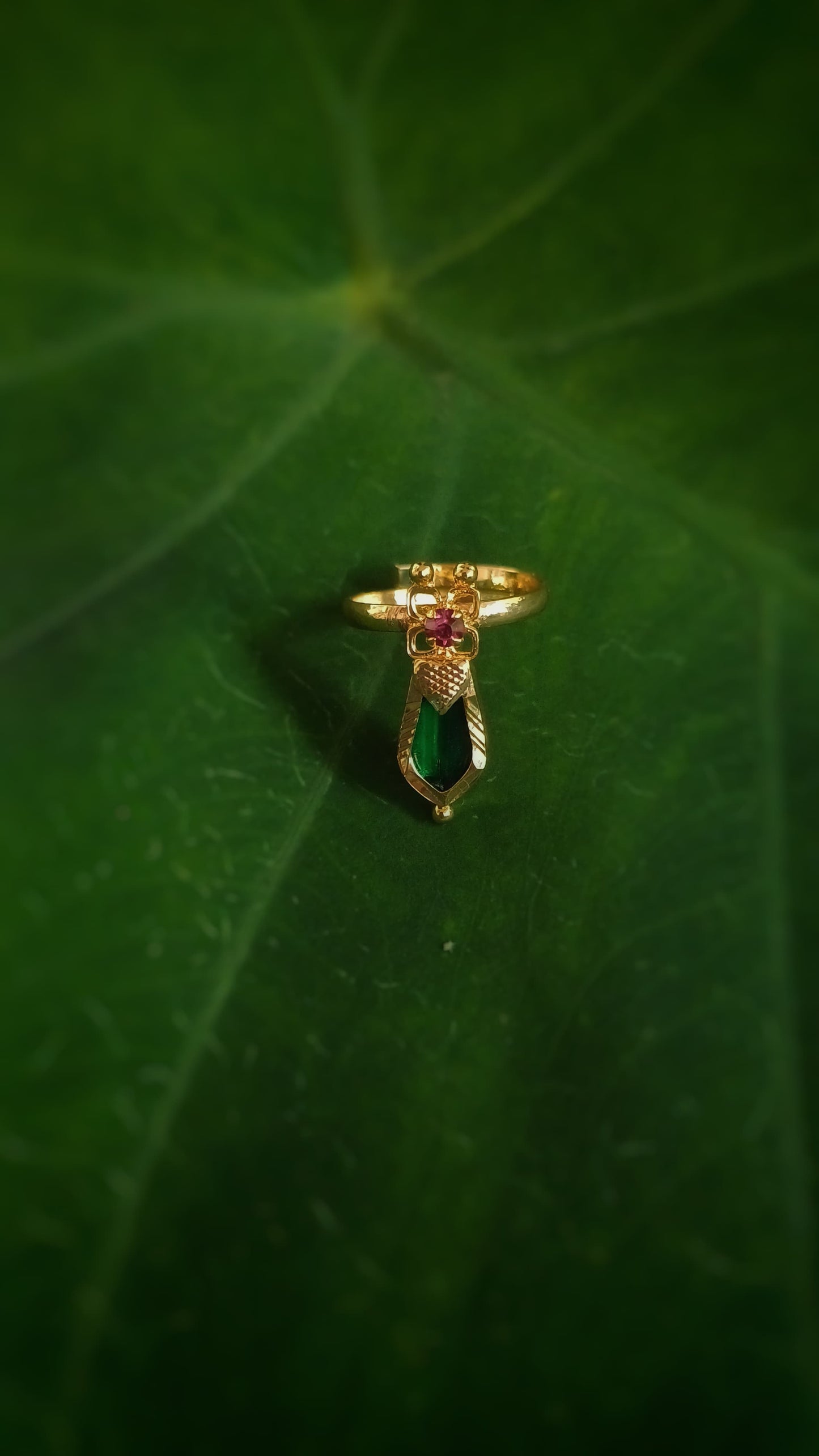 Small gold plated finger ring with ruby red ad stone and Green Nagapadam design stone