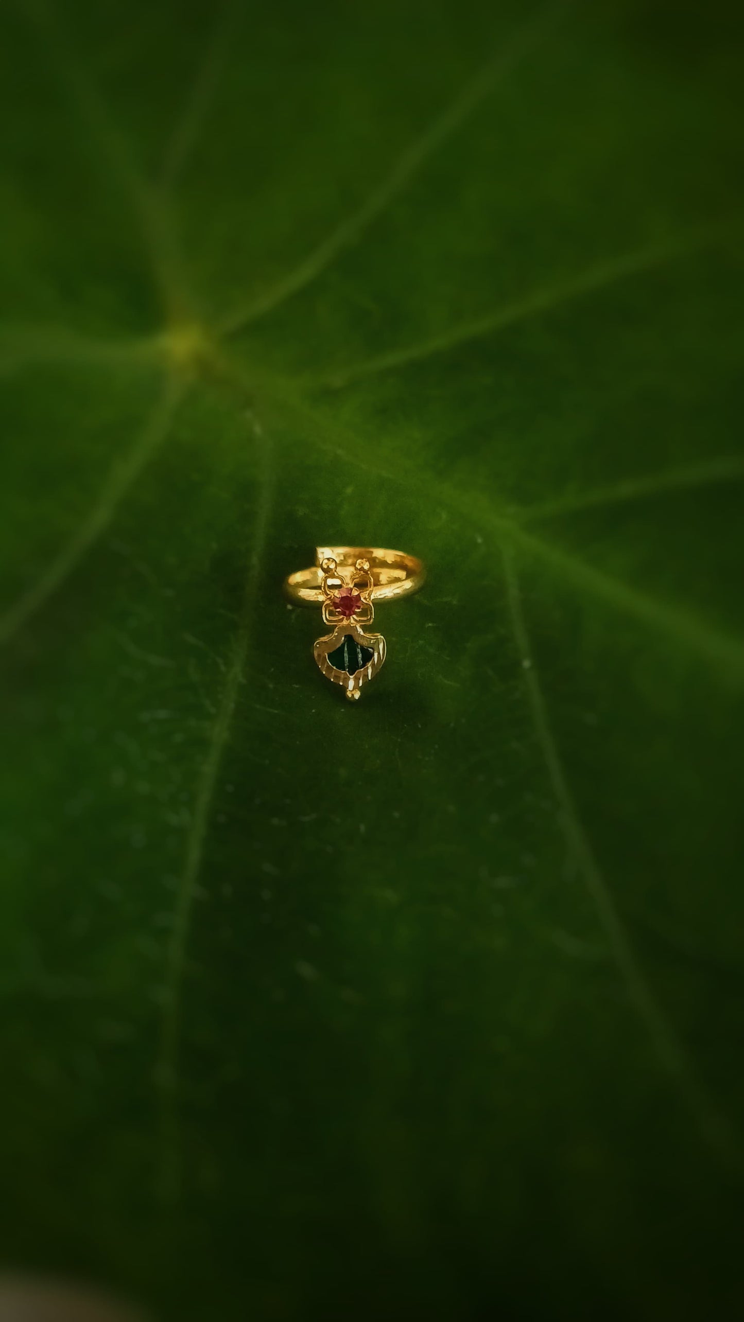 Small gold plated adjustable finger ring with green palakka design stone